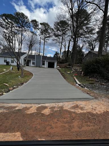 Wooded residential driveway with new gravel and grading.