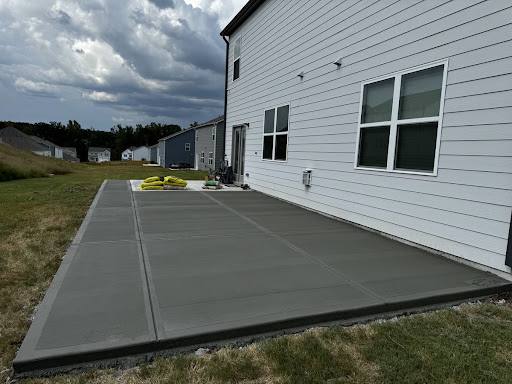 Existing concrete patio and driveway before renovation.